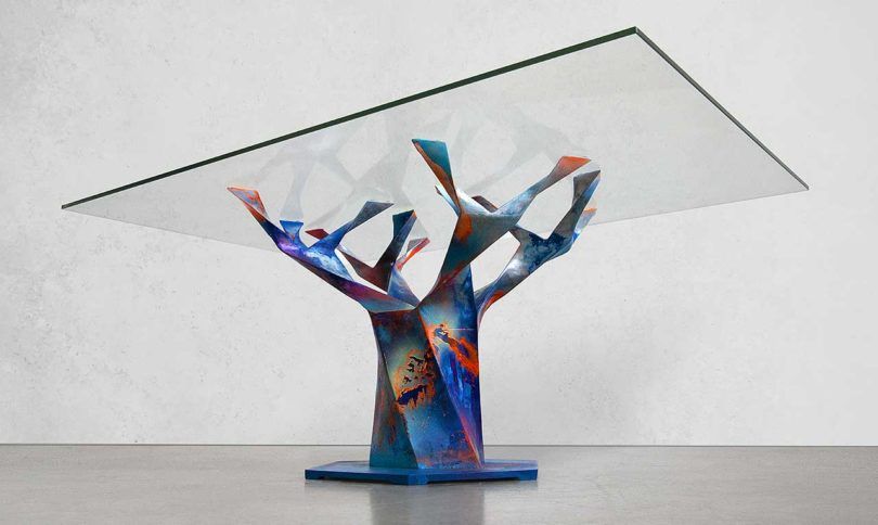 Glass top supported by an art piece