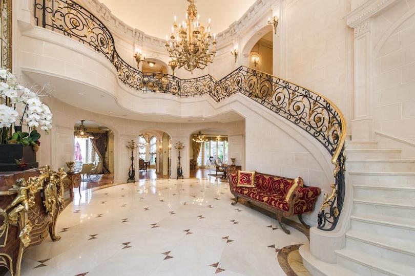 Grand Foyer with Marble Staircase & Ornate Wrought Iron Railings