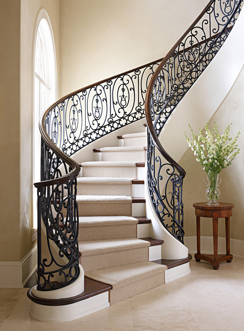 Modern Foyer With Curved Staircase And Iron Railings