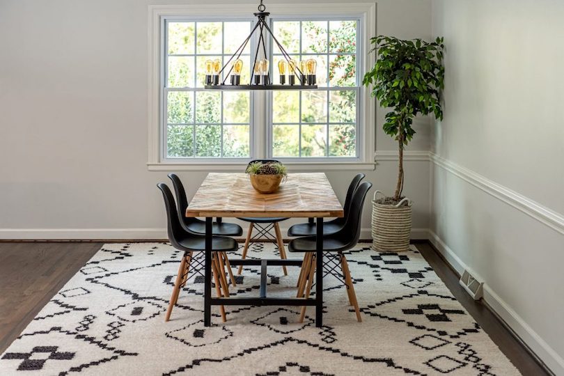 Define the dining room with an area rug