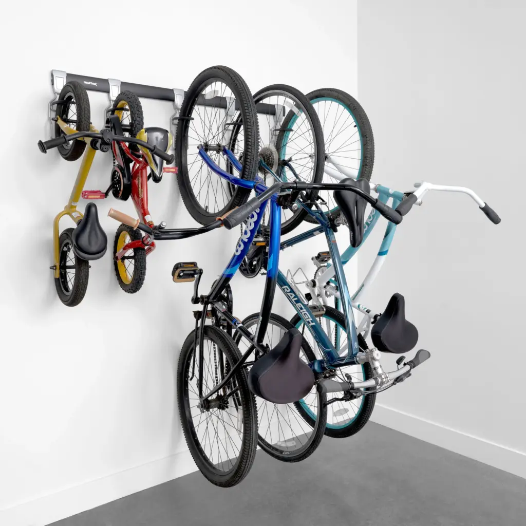 Wall track system in a garage with bike hooks, a helmet hook and a shelf